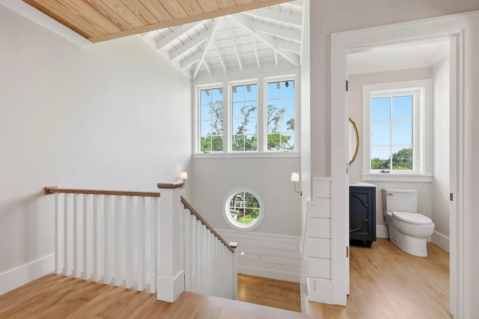 Stair landing with vaulted cupola, clerestory windows and round porthole window